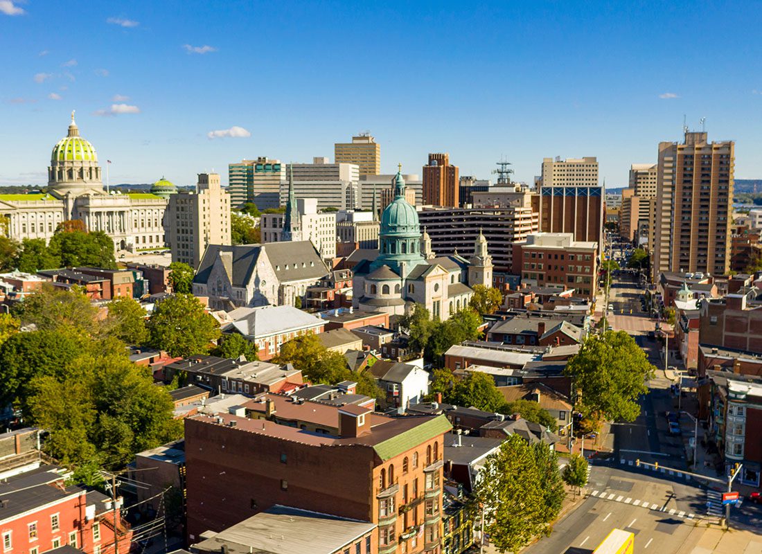 Contact - Aerial View of Commercial and Apartment Buildngs in Downtown Harrisburg Pennsylvania Next to the Capitol Building Against a Clear Blue Sky