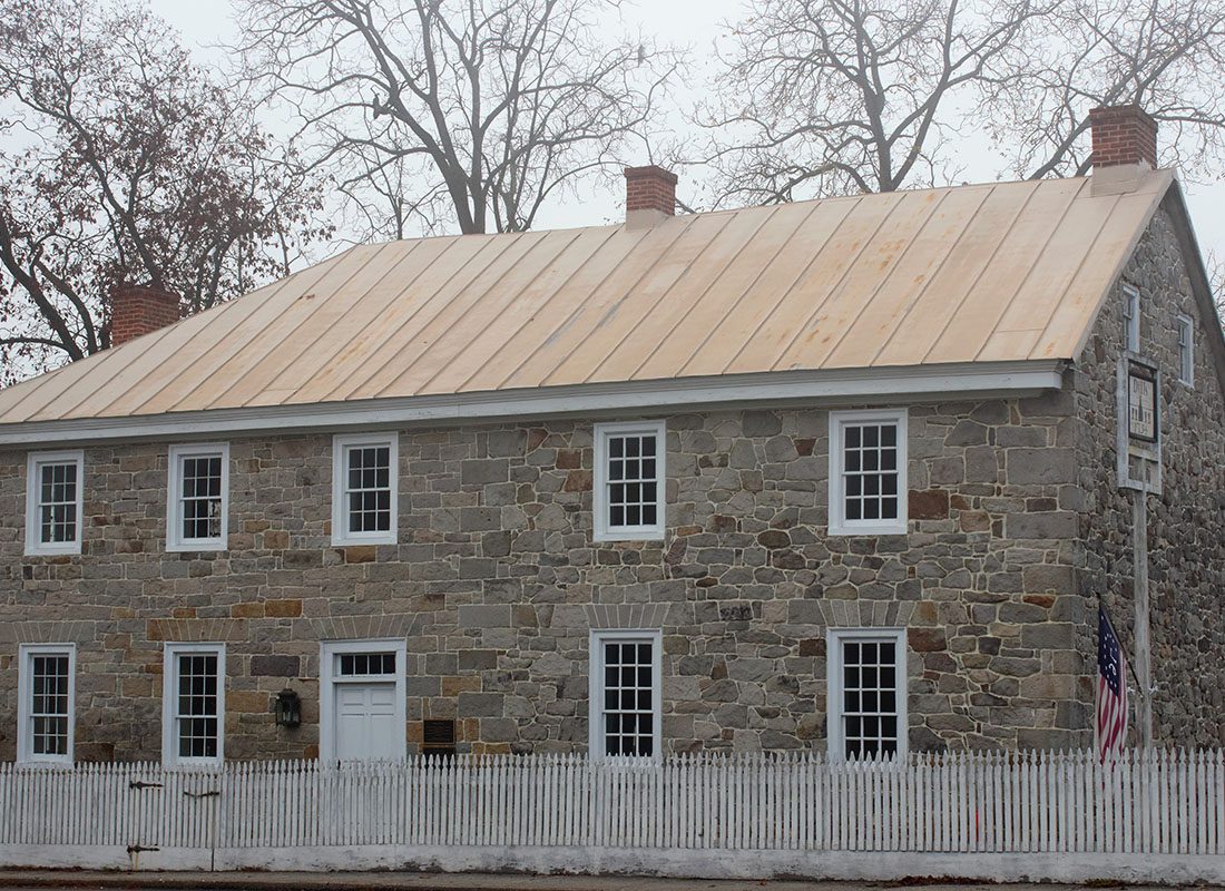 Dillsburg, PA - Exterior View of a Historical Stone Building in Dillsburg Pennsylvania with the JPI Insurance Associates Office Next to a White Picket Fence